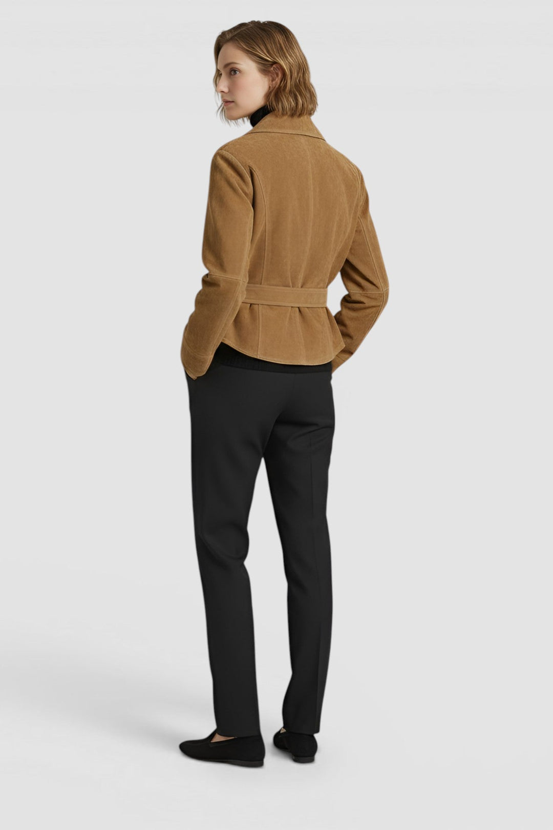 ADELINE - Model in camel suede jacket, black turtleneck, and black trousers Back View
