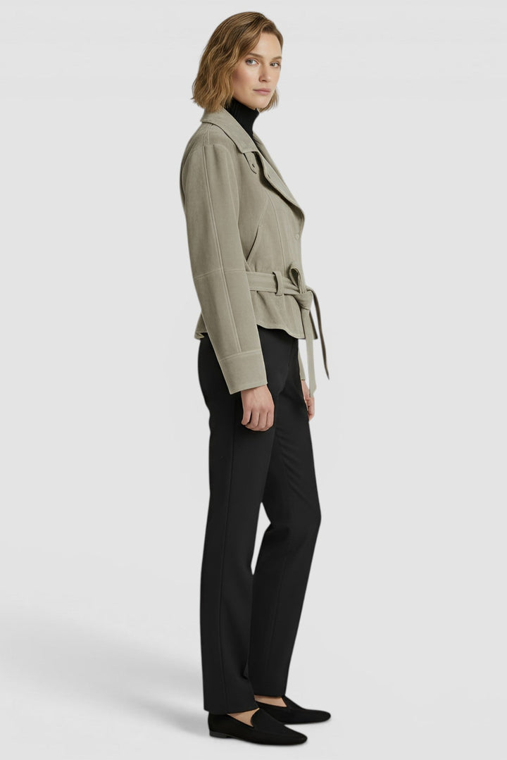 ADELINE - Side profile of model in greenish-tan suede jacket and black trousers