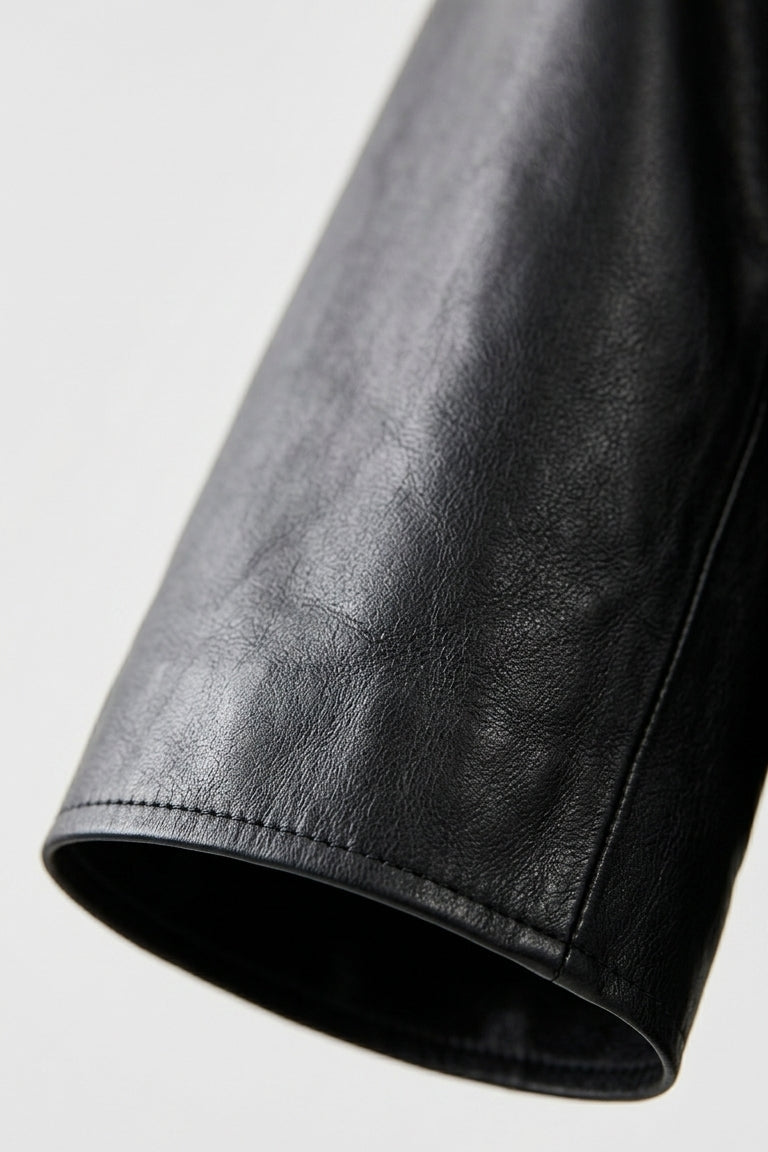 AUDREY - Close-up of a black leather sleeve on a light gray background