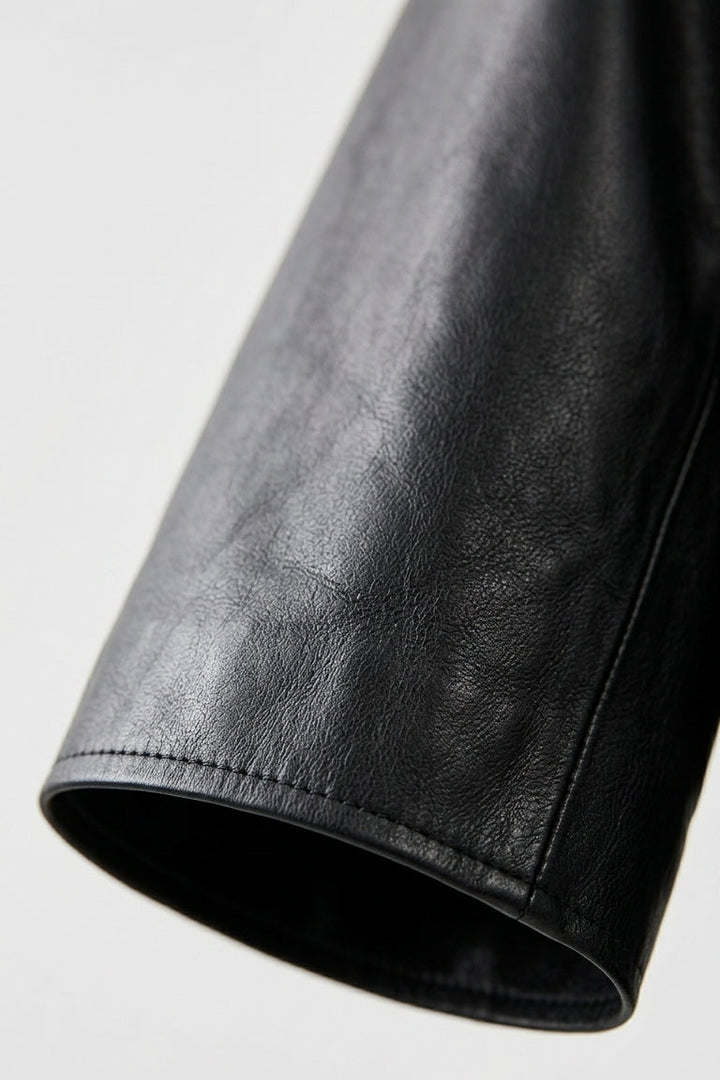 AUDREY - Close-up of a black leather sleeve on a light gray background