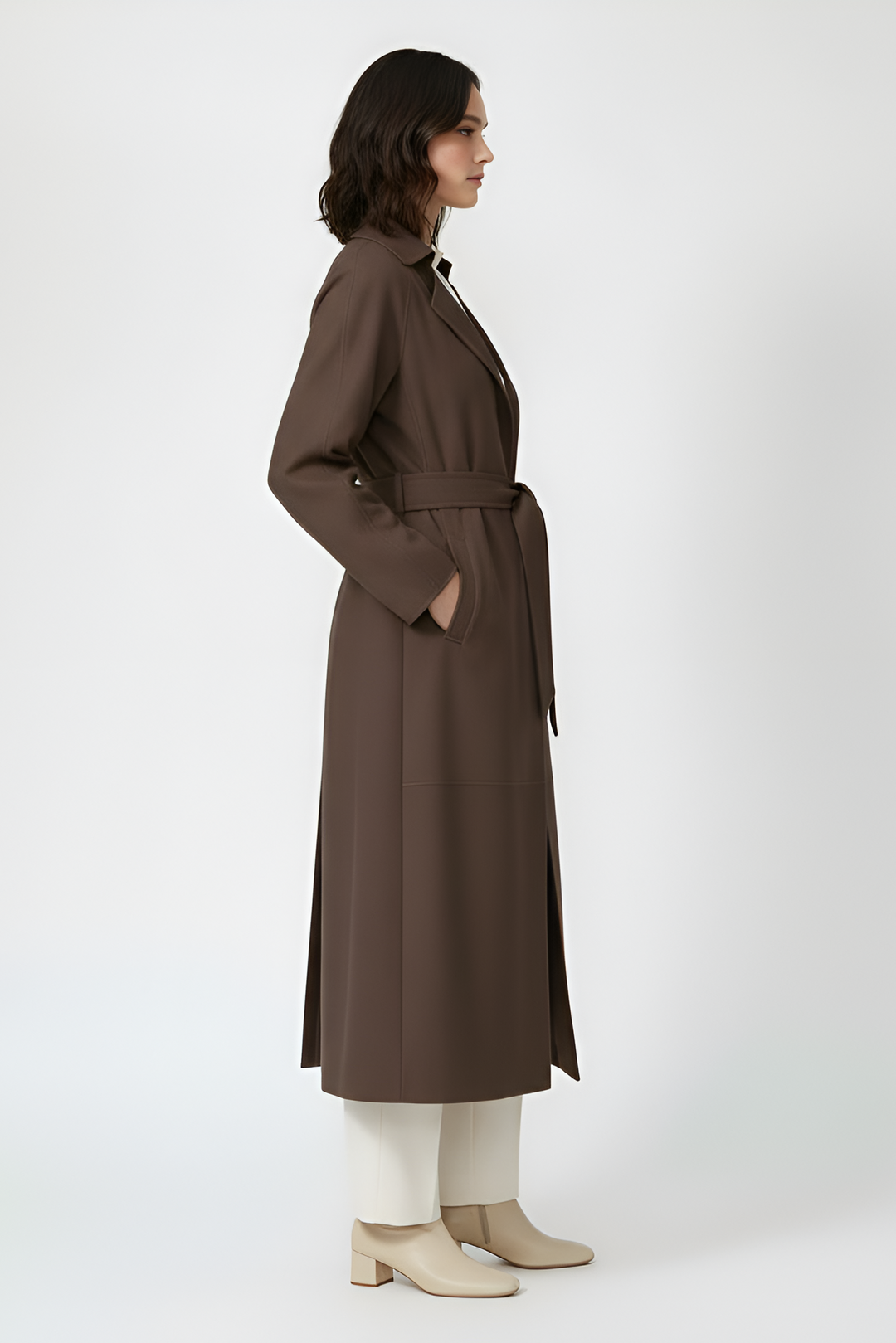 AURORA - Dark brown suede trench coat on model, side view with hands in pockets