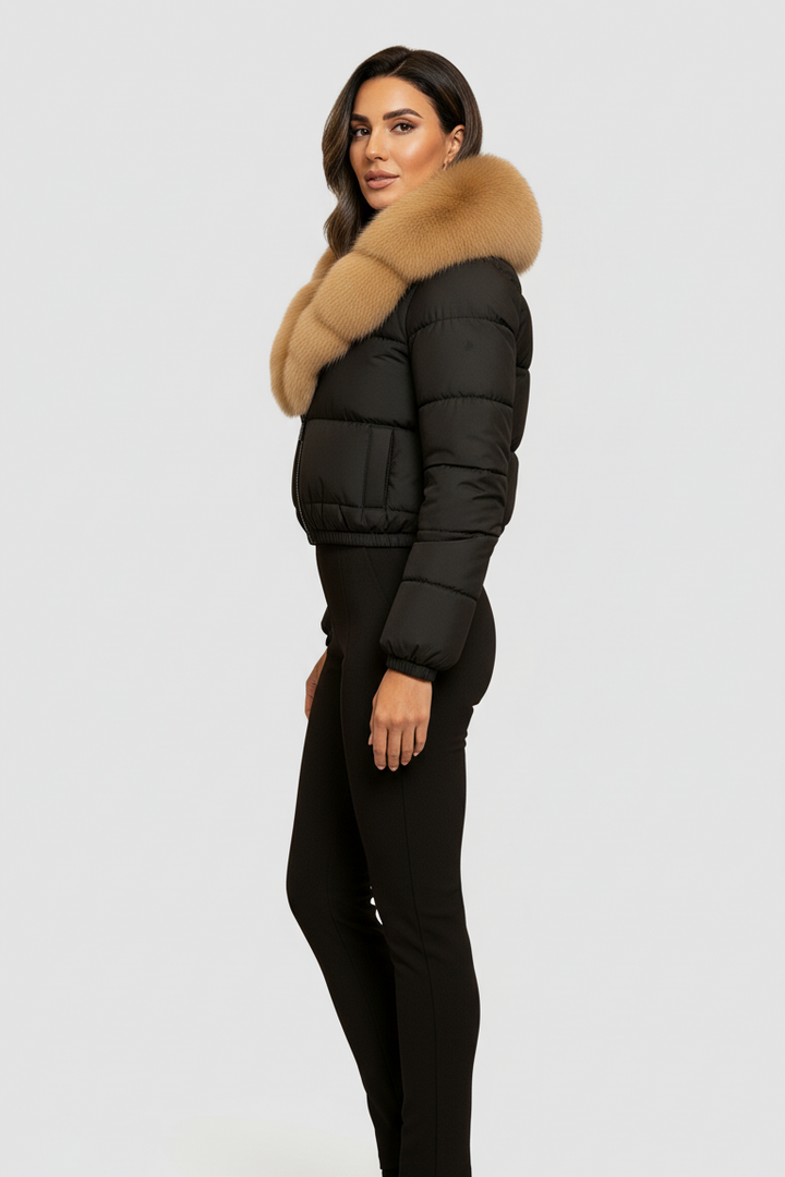 Woman wearing a black puffer jacket with a fur collar on a white background
