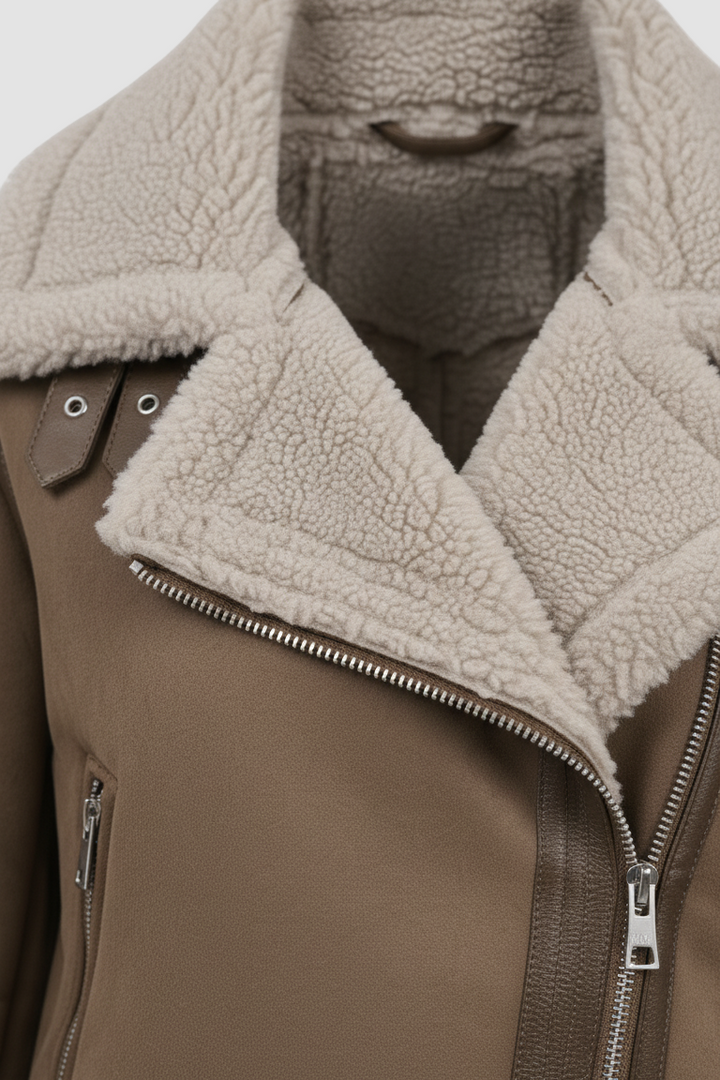 A brown leather jacket styled with a white top.