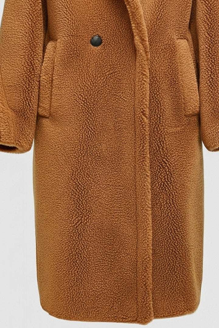 A brown teddy coat set against a light gray background.