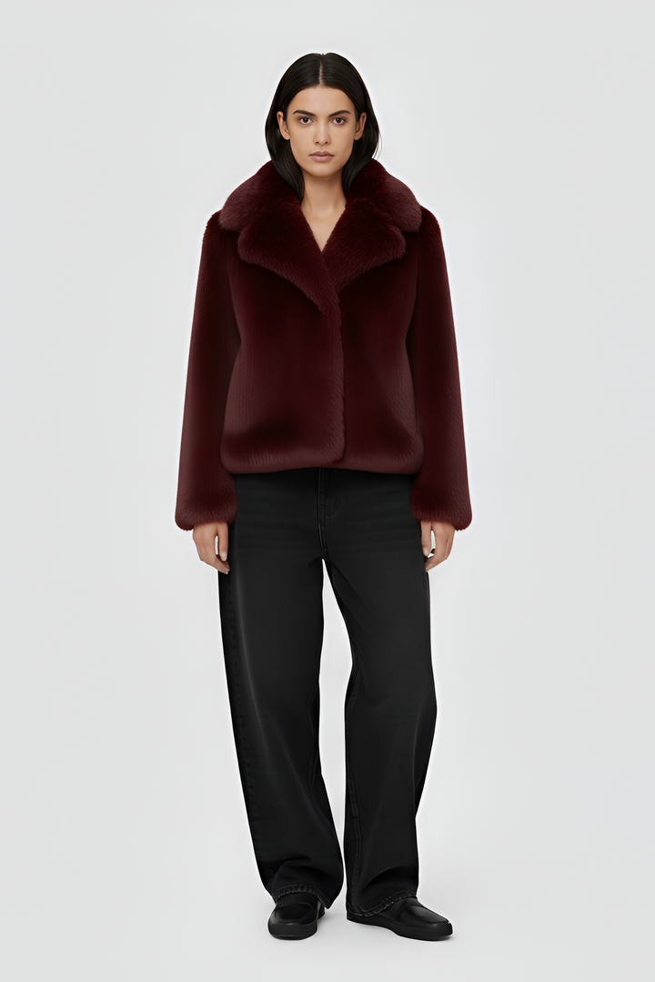 A burgundy fur coat against a white background.