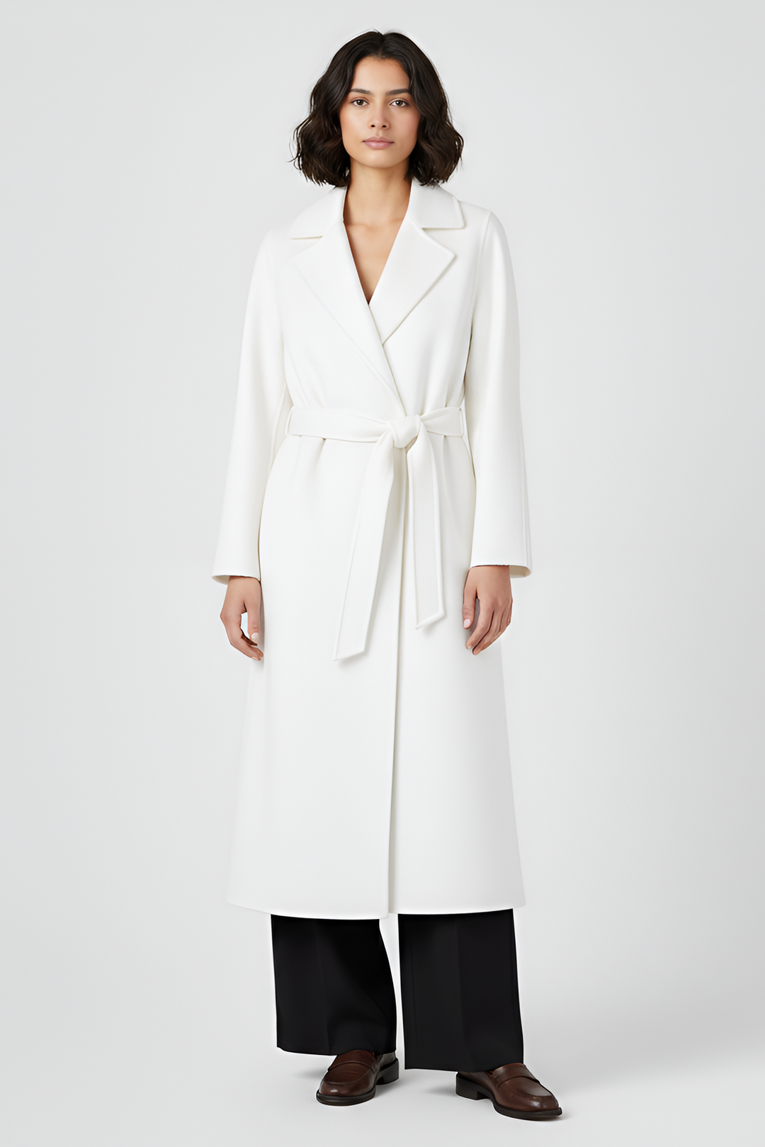 Woman wearing a white coat on a plain background
