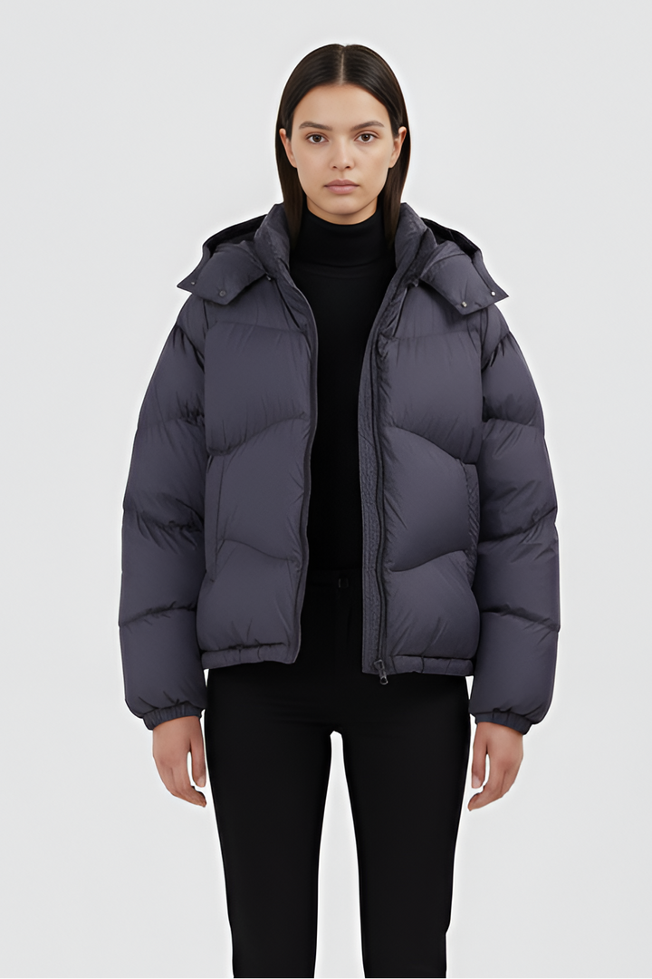 Back view of LYORE Unisex Lightweight Down Jacket in matte charcoal, highlighting its clean quilting and hooded design.