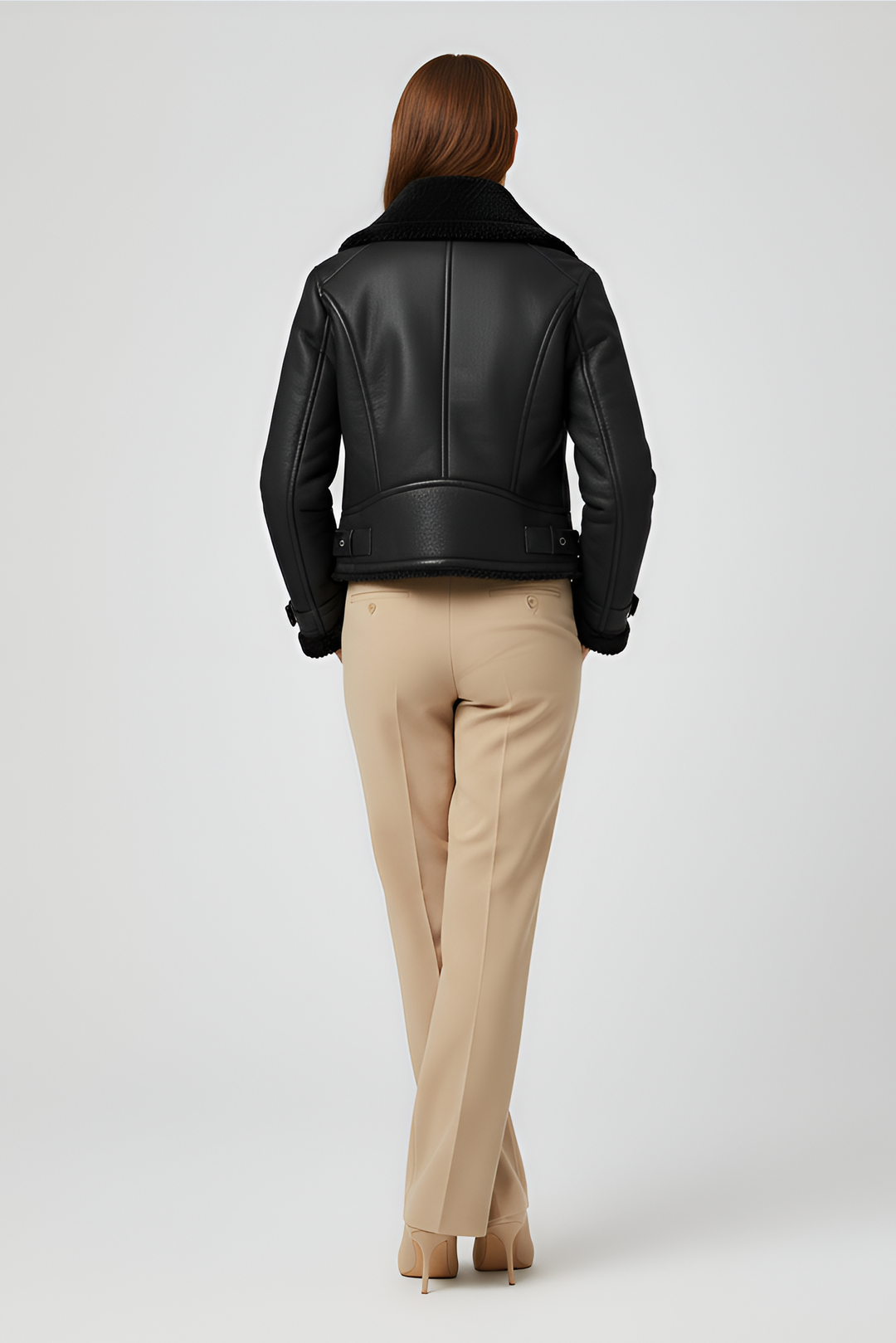 Back view of black faux fur lined cropped biker jacket with matte finish