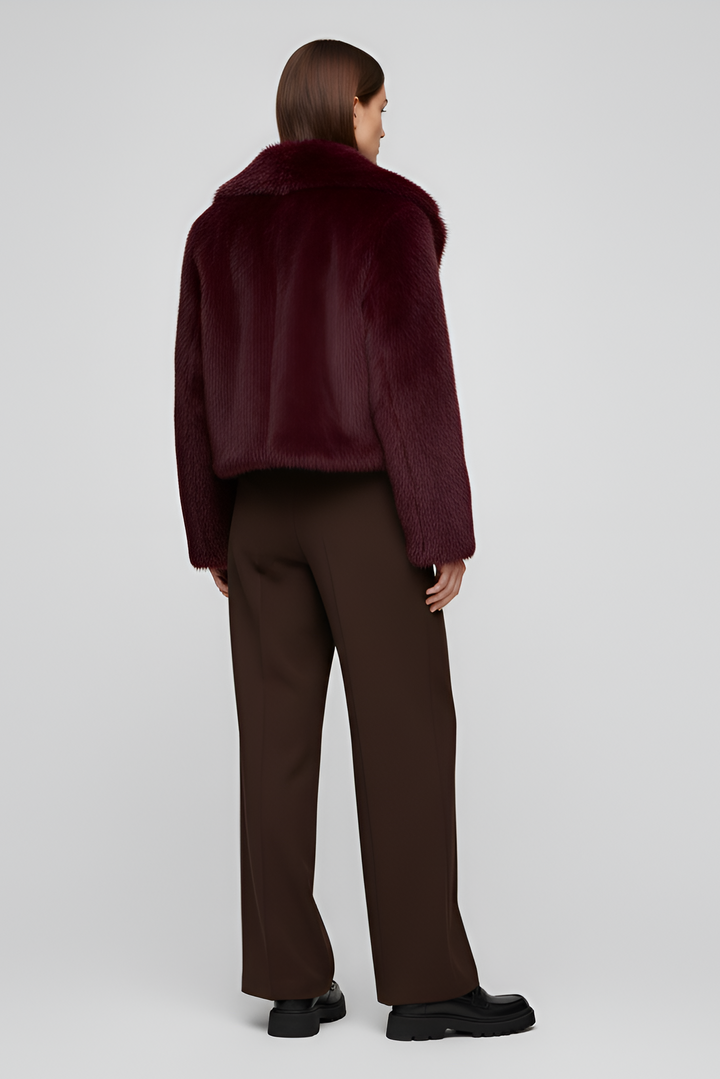 Back view showing the soft faux fur texture and cropped silhouette of the Camelia deep burgundy winter coat.