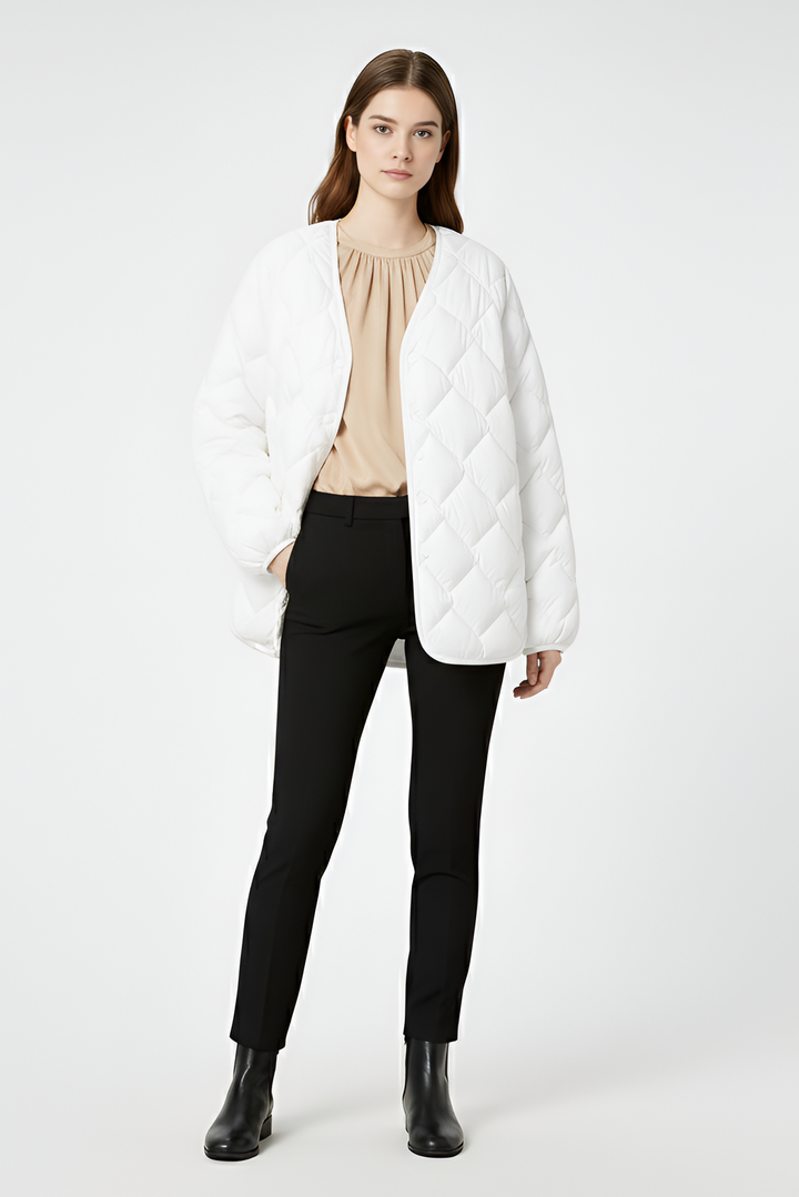 Beige quilted winter coat featuring rounded hemline