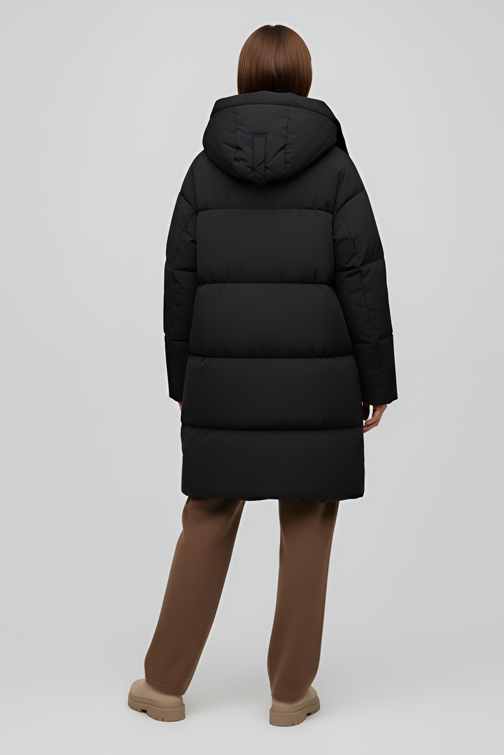 Person wearing a black puffer coat against a white background