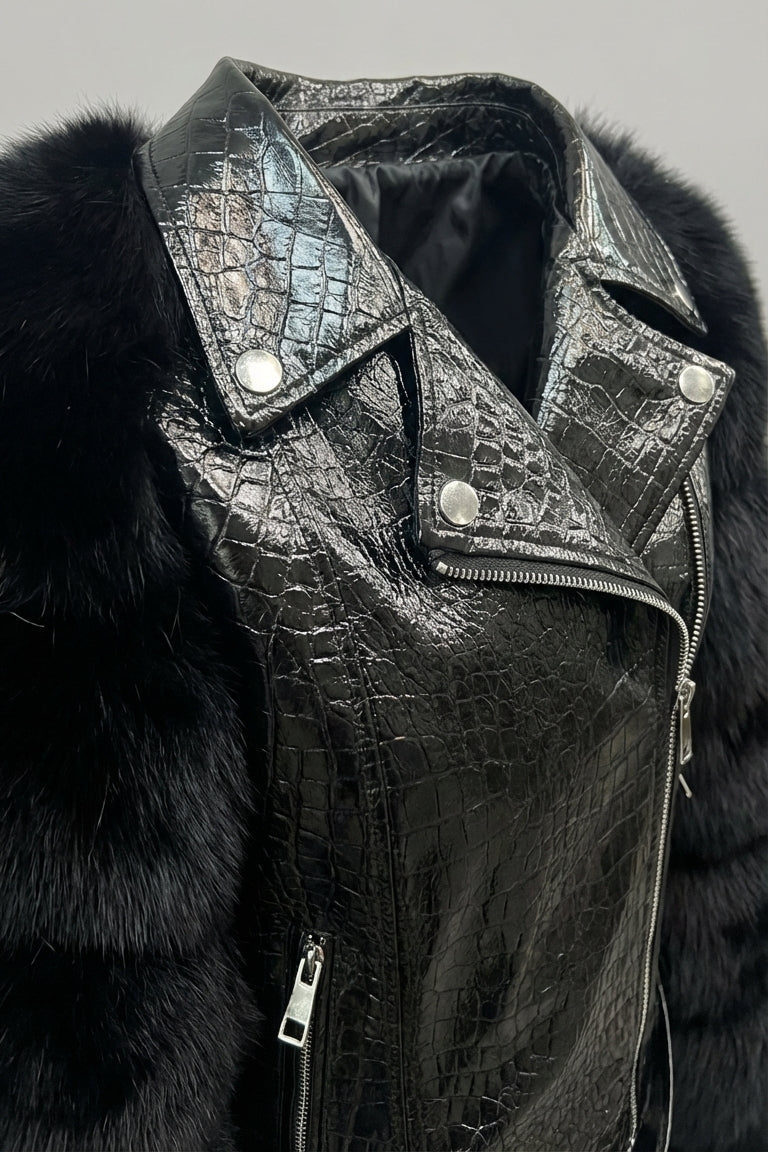 Black leather jacket with fur collar and crocodile texture on a gray background