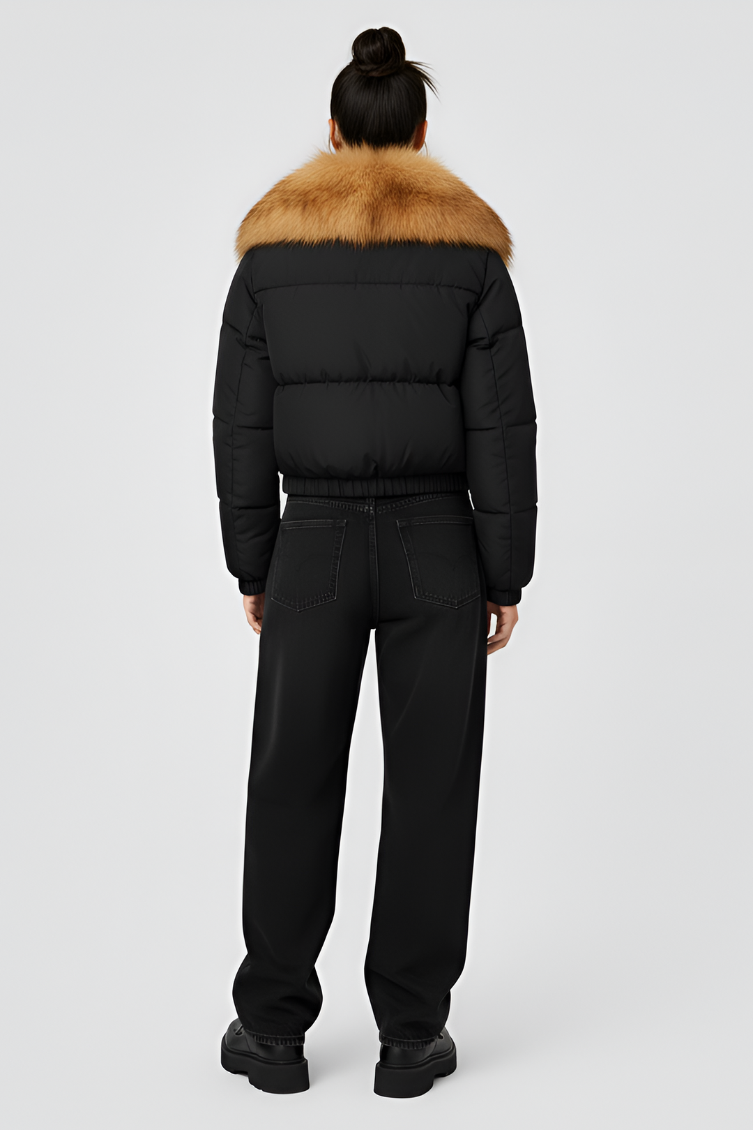 Black puffer jacket with brown fur collar on a light gray background