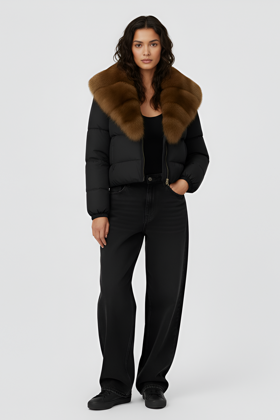 Black puffer jacket with brown fur collar on a light gray background