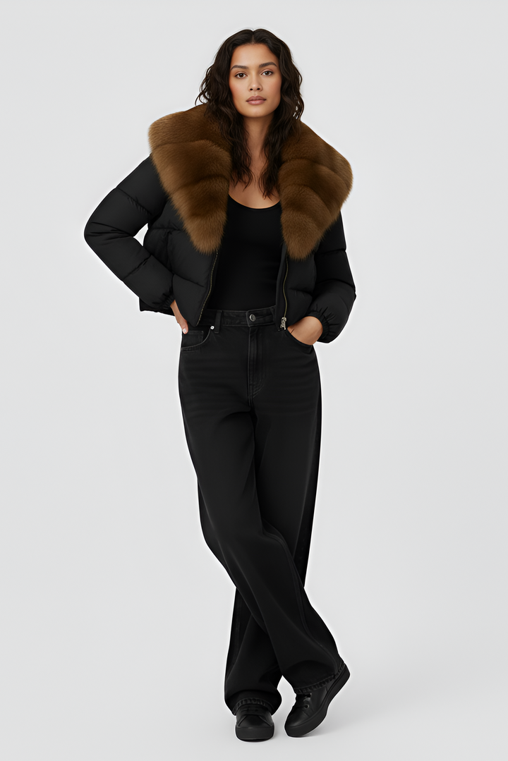 Black puffer jacket with brown fur collar on a light gray background