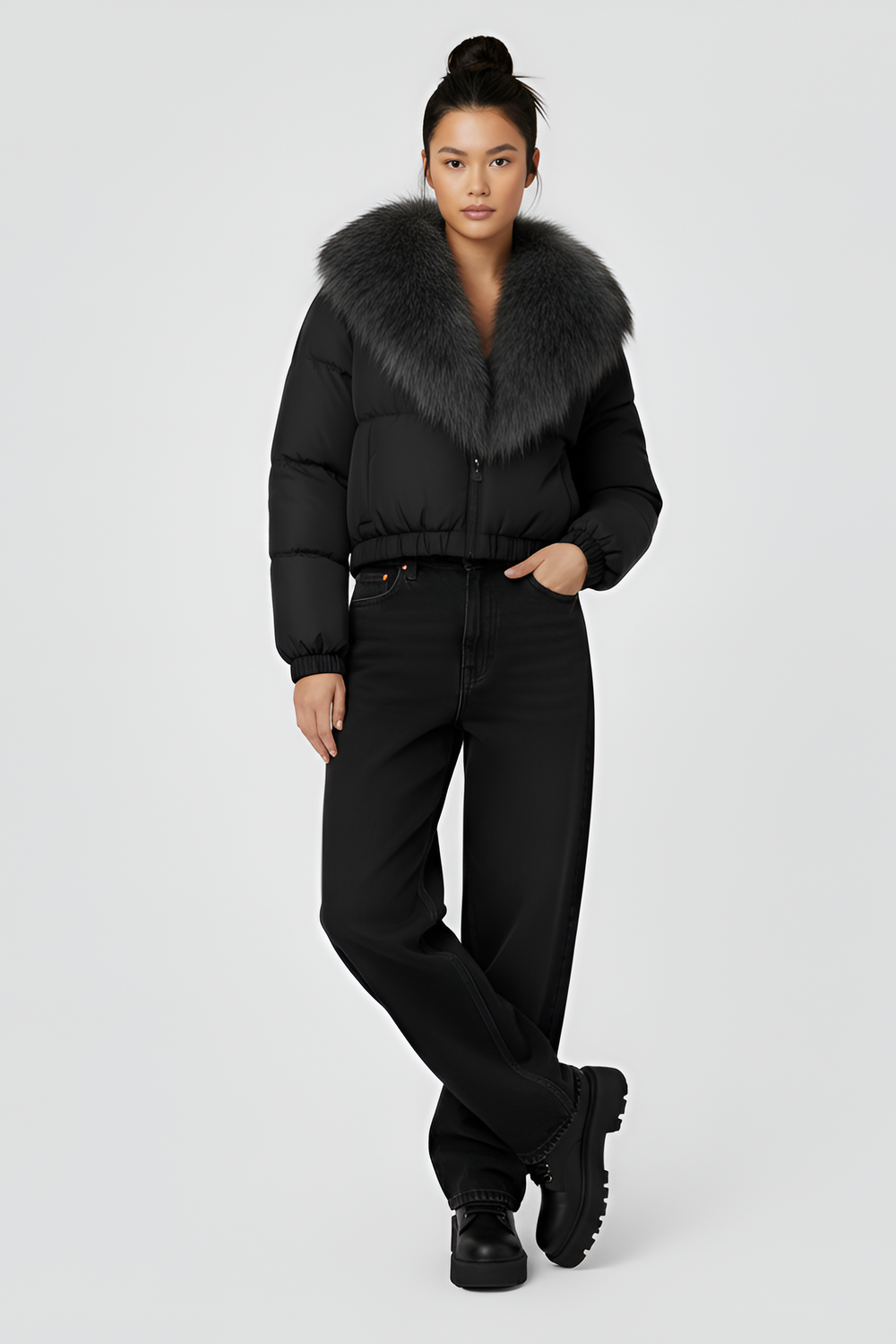 Black puffer jacket with gray fur collar on a light gray background