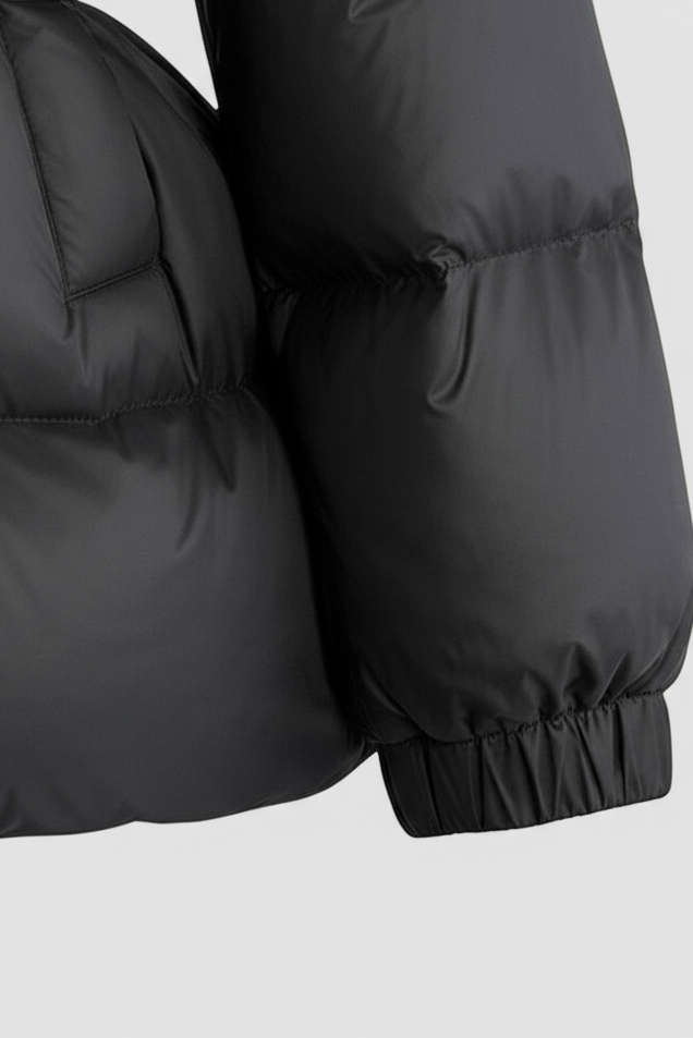Black puffer jacket with matching gloves on a light gray background