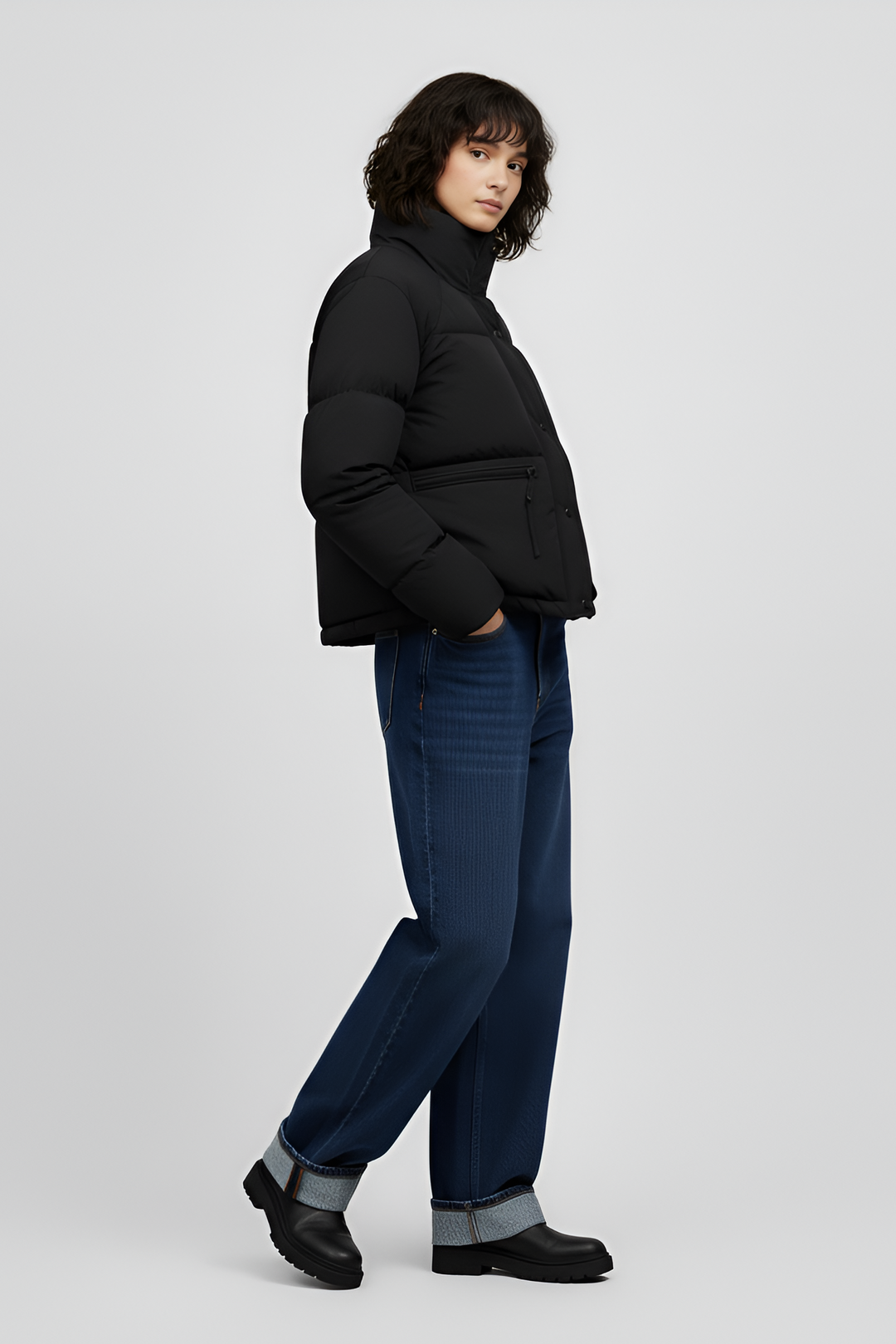 Woman wearing a red jacket and black jeans on a white background