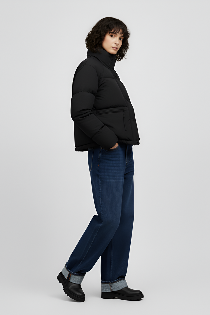 Woman wearing a red jacket and black jeans on a white background