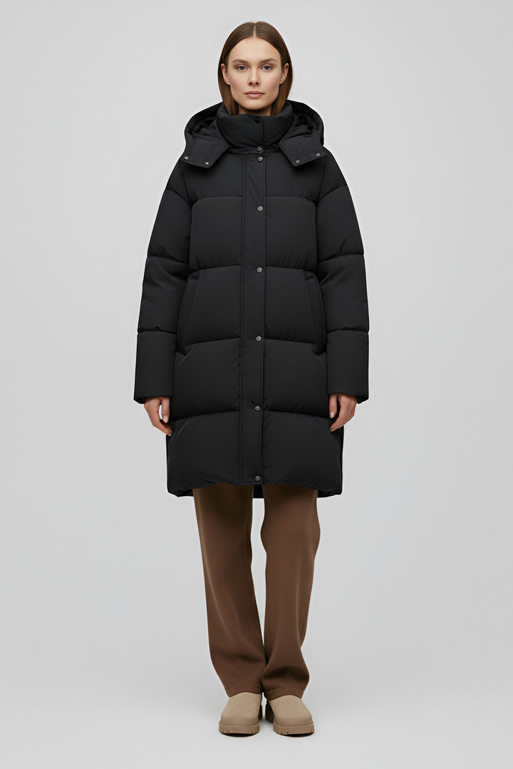 Person wearing a black puffer coat against a white background