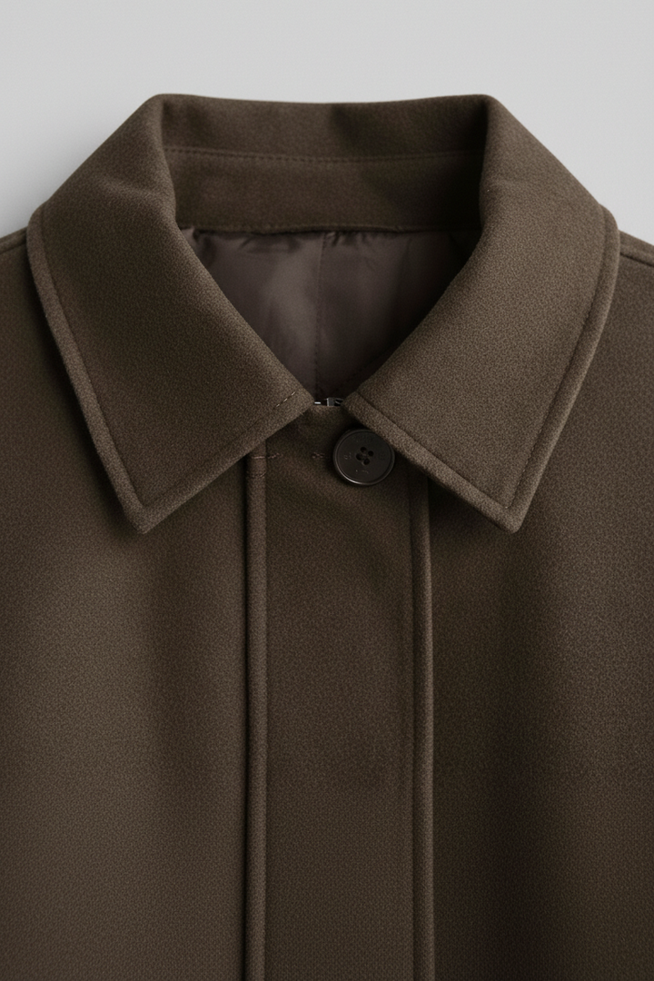 Brown coat with a collar on a light gray background