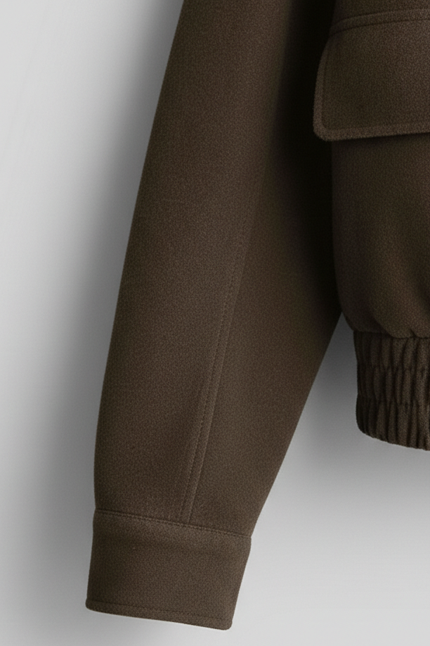 Brown jacket sleeve on a light gray background