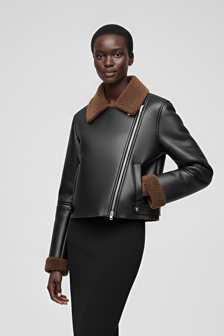 Close-up front view of faux leather cropped jacket with brown fleece details.