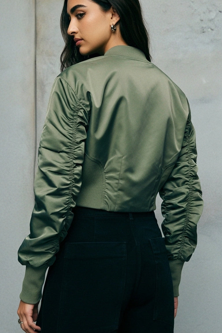 Close-up of AERLYN Cropped Bomber Jacket zipper and pocket design on smooth olive fabric.