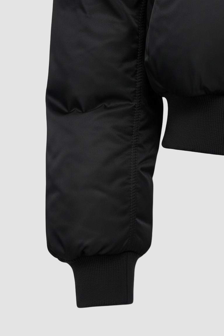 Close-up of CAELIA Oversized Bomber Jacket pocket and zipper detail with smooth woven texture.