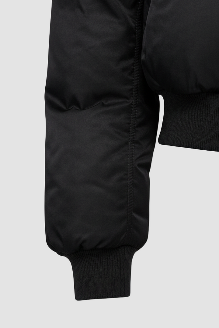 Close-up of CAELIA Oversized Bomber Jacket pocket and zipper detail with smooth woven texture.