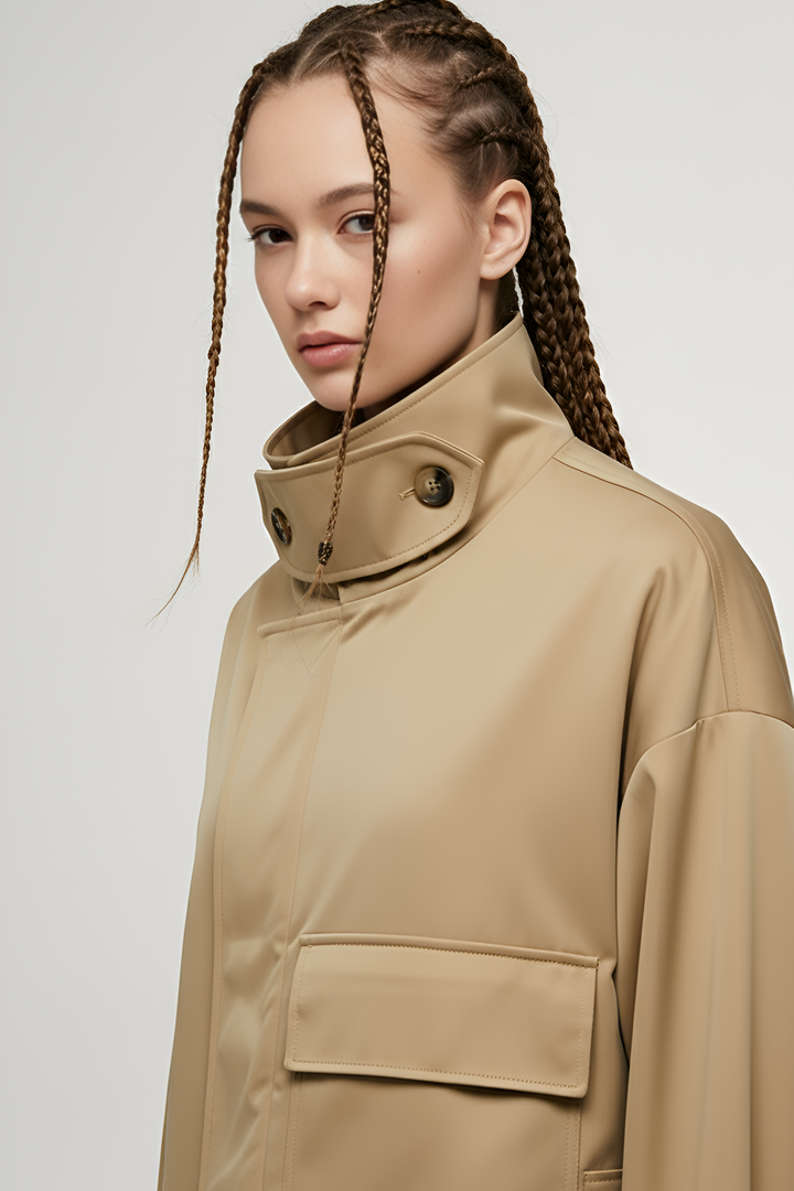 Close-up of ENVARA woven polyester coat highlighting glossy finish, zipper, and stitching.