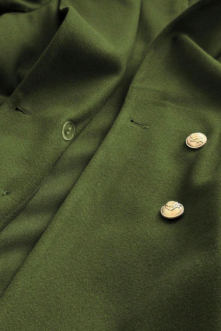 Close-up of a green coat with buttons