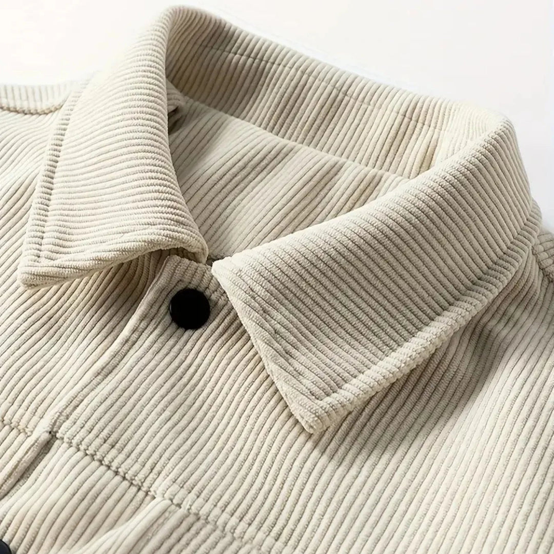 Close-up of a beige corduroy jacket with a collar on a white background
