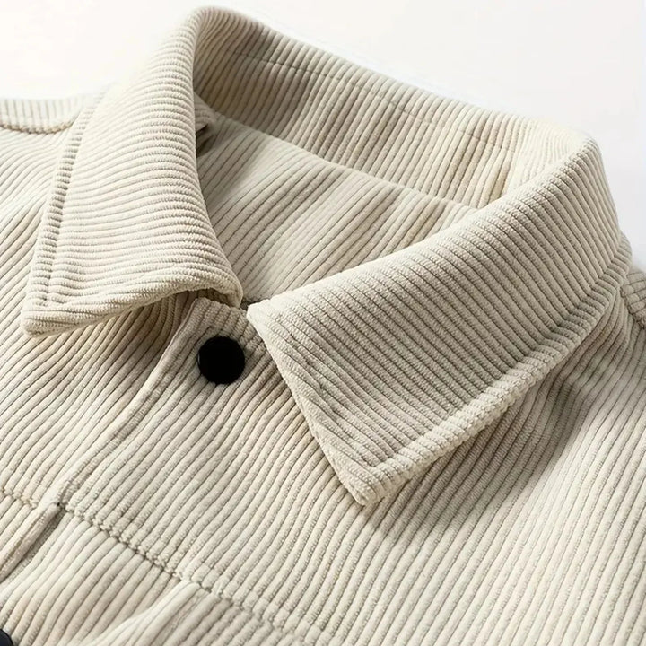 Close-up of a beige corduroy jacket with a collar on a white background