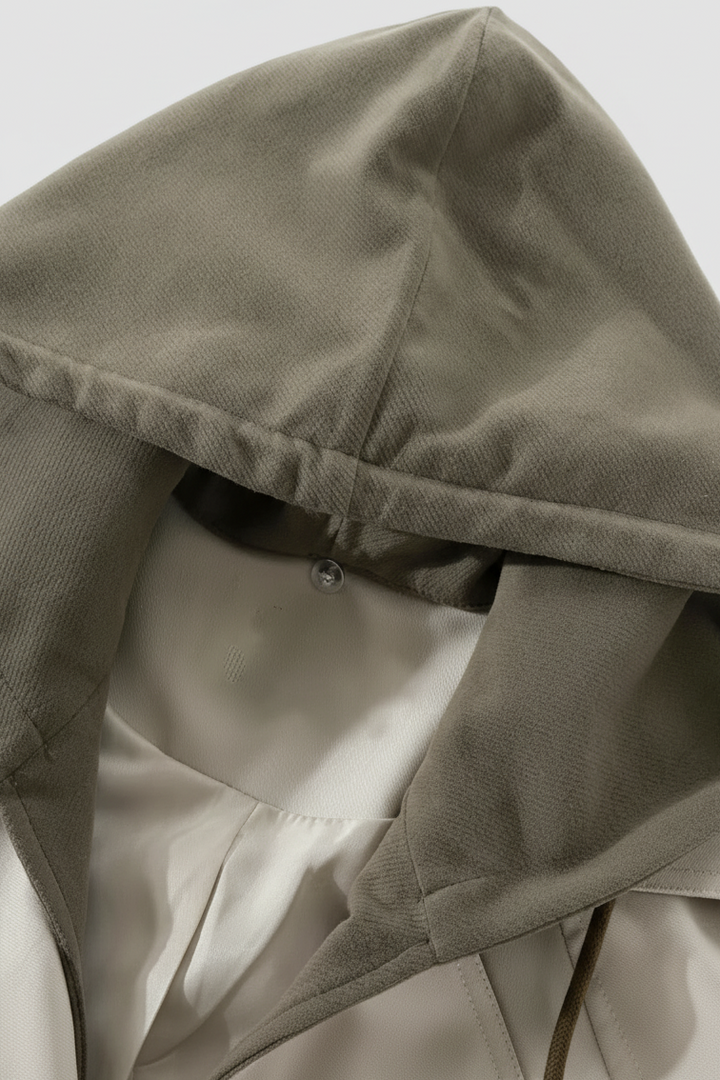 Close-up of a beige hooded jacket on a light gray background