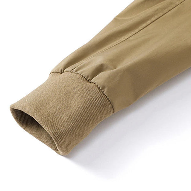 Close-up of a beige jacket sleeve on a white background