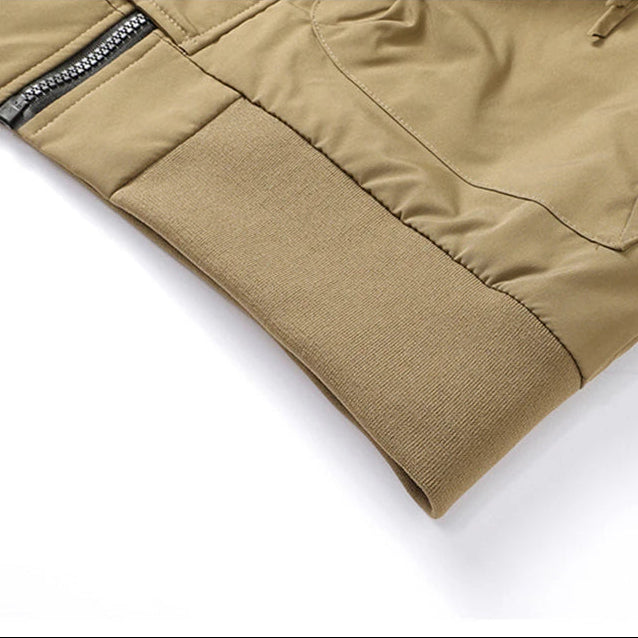 Close-up of a beige jacket with a zipper on a white background