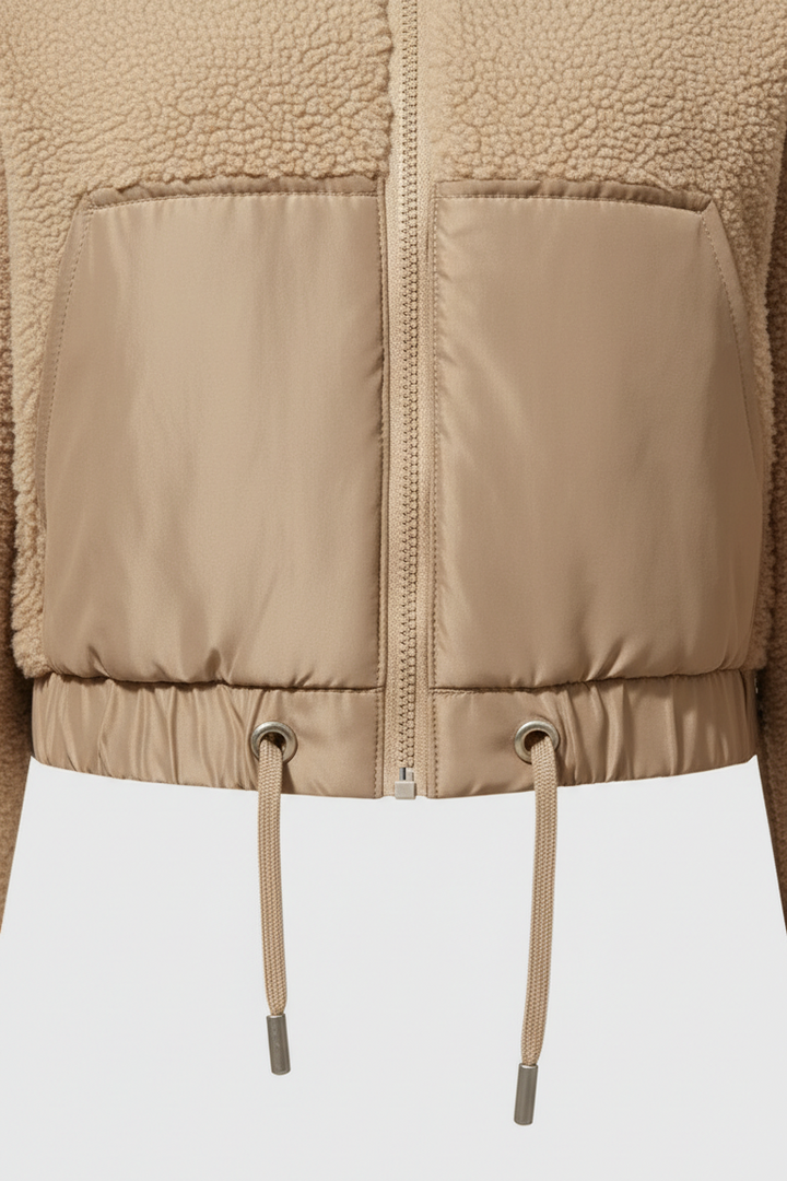 Close-up of a beige puffer jacket with a white background