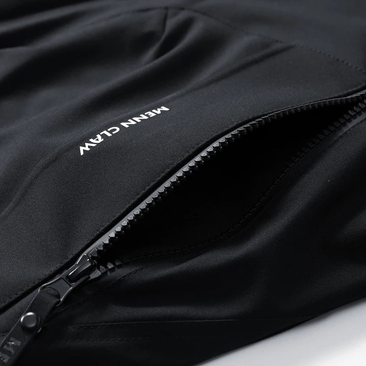 Close-up of a black jacket with a zipper, featuring the brand 'Menn Claw' on a white background.
