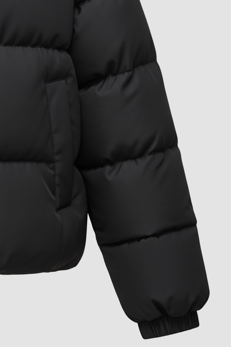 Close-up of a black puffer jacket on a white background