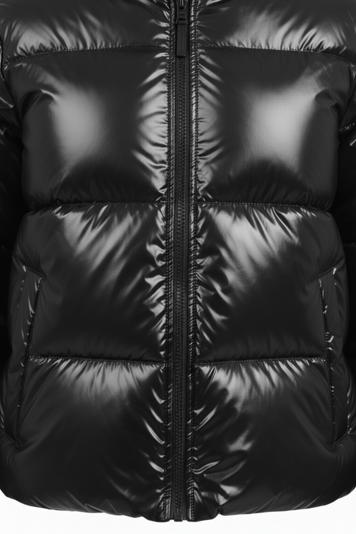 Close-up of a black puffer jacket with a zipper on a white background