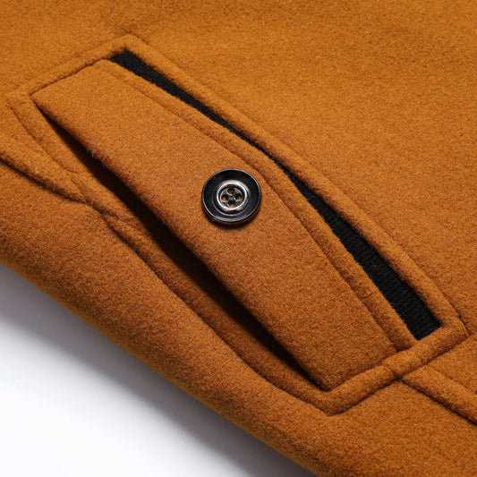 Close-up of a brown coat with a button on a white background