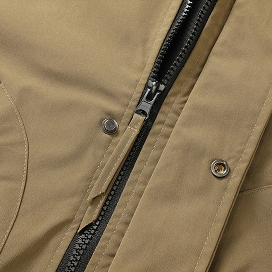 Close-up of a brown jacket with a black zipper and buttons.