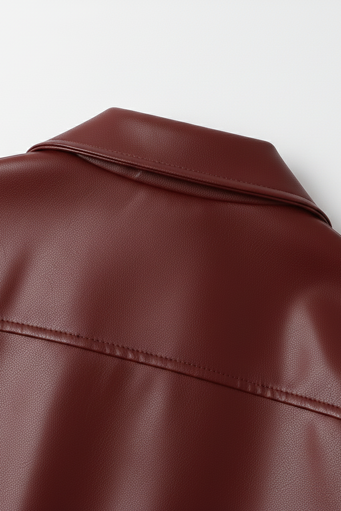 Close-up of a brown leather jacket on a white background