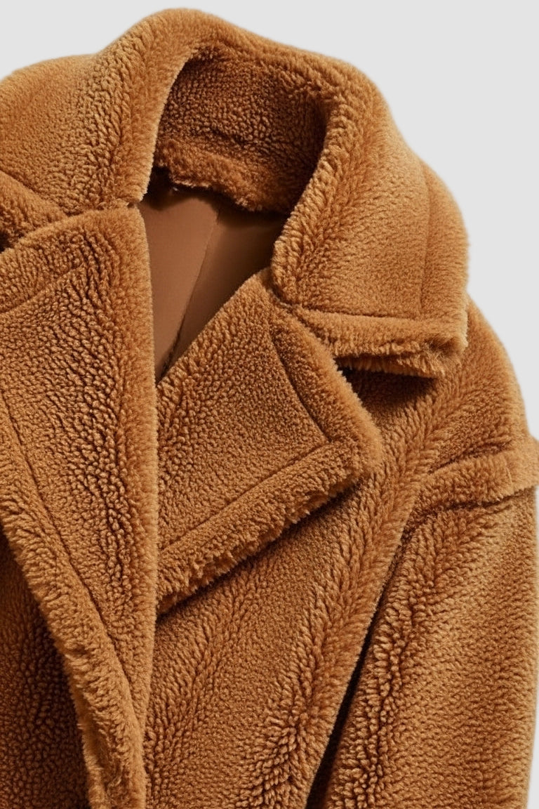 Close-up of a brown textured coat with a neutral background