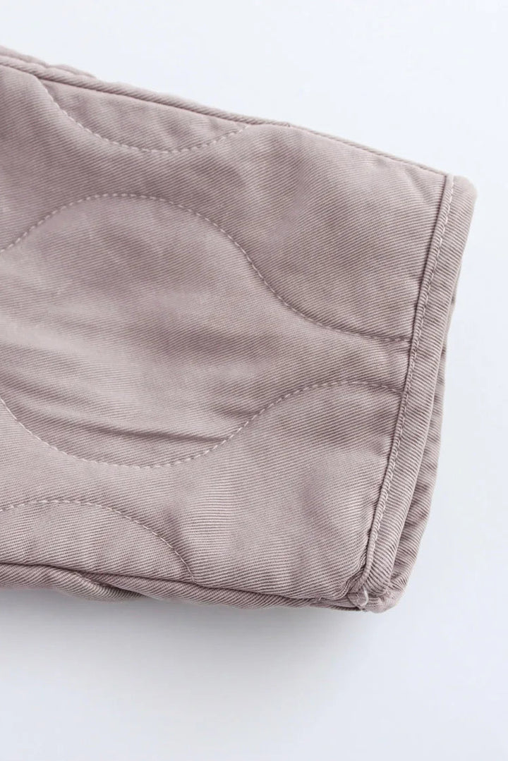 Close-up of a folded beige fabric on a white background
