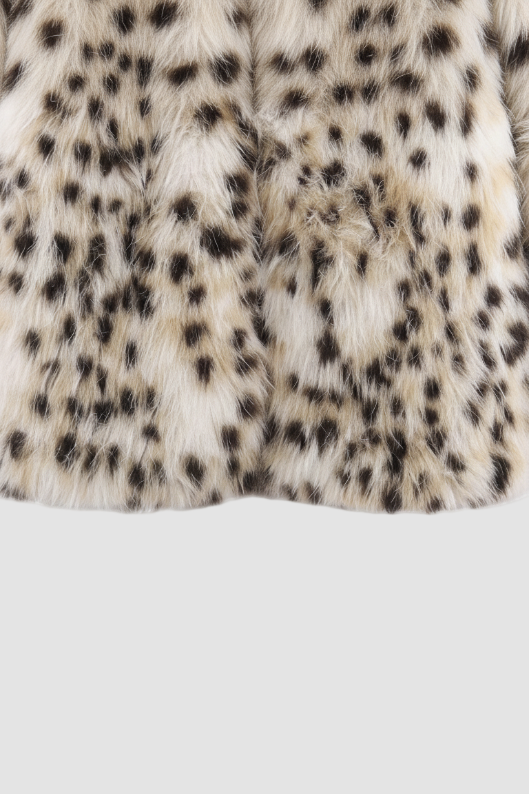 Close-up of a fur coat with a leopard print pattern on a white background