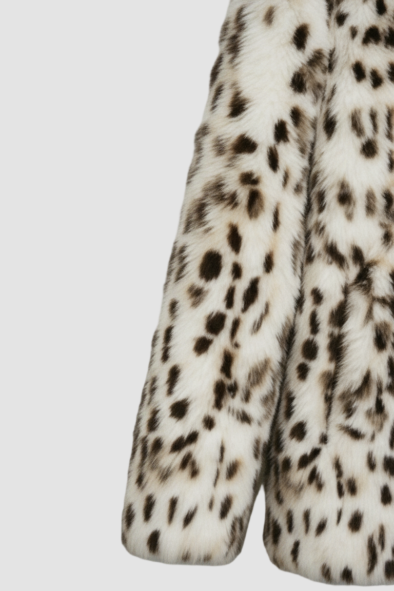 Close-up of a leopard print fur coat on a light gray background