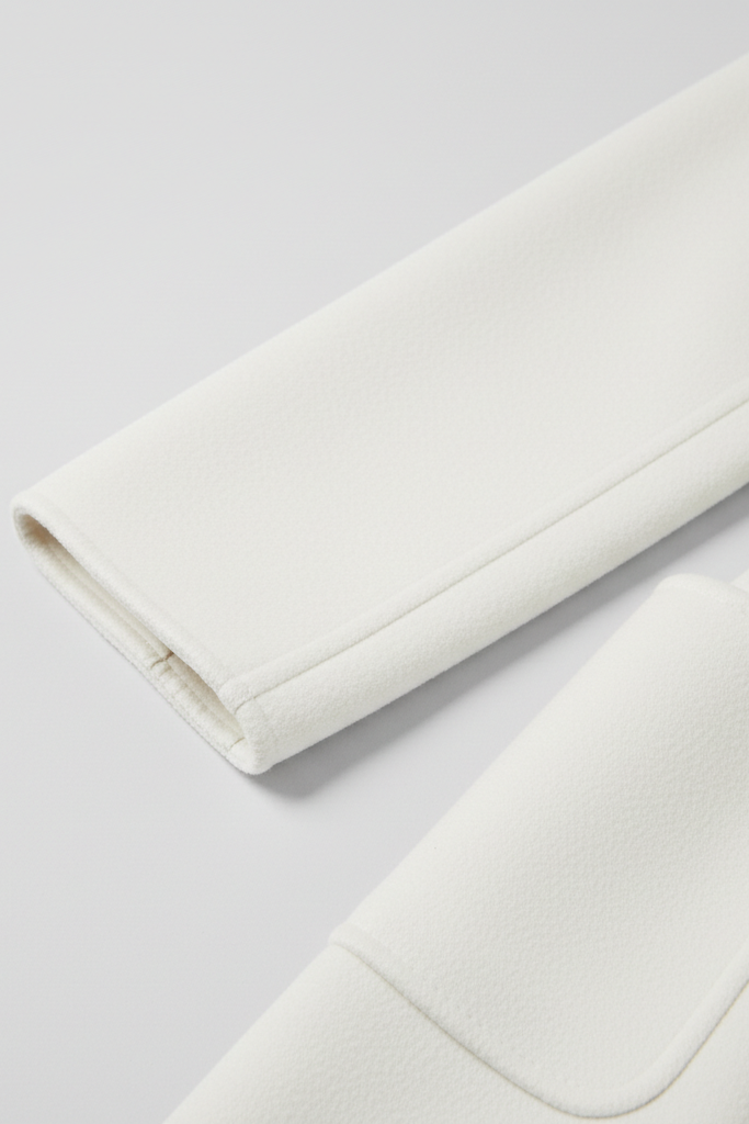 Close-up of a white fabric roll on a light gray background