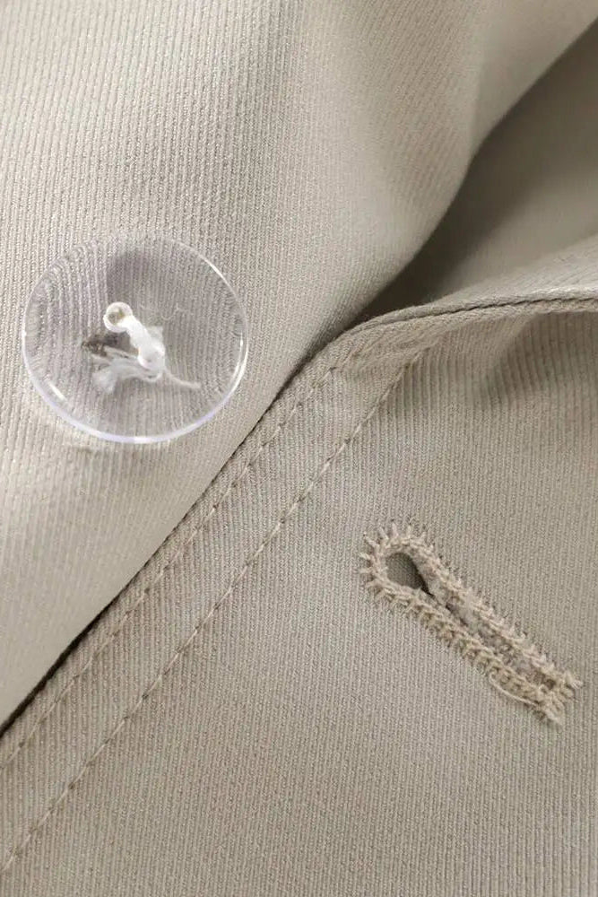 Close-up of beige fabric with a button and stitching detail